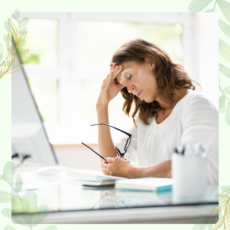 woman stressed at work with hand on head