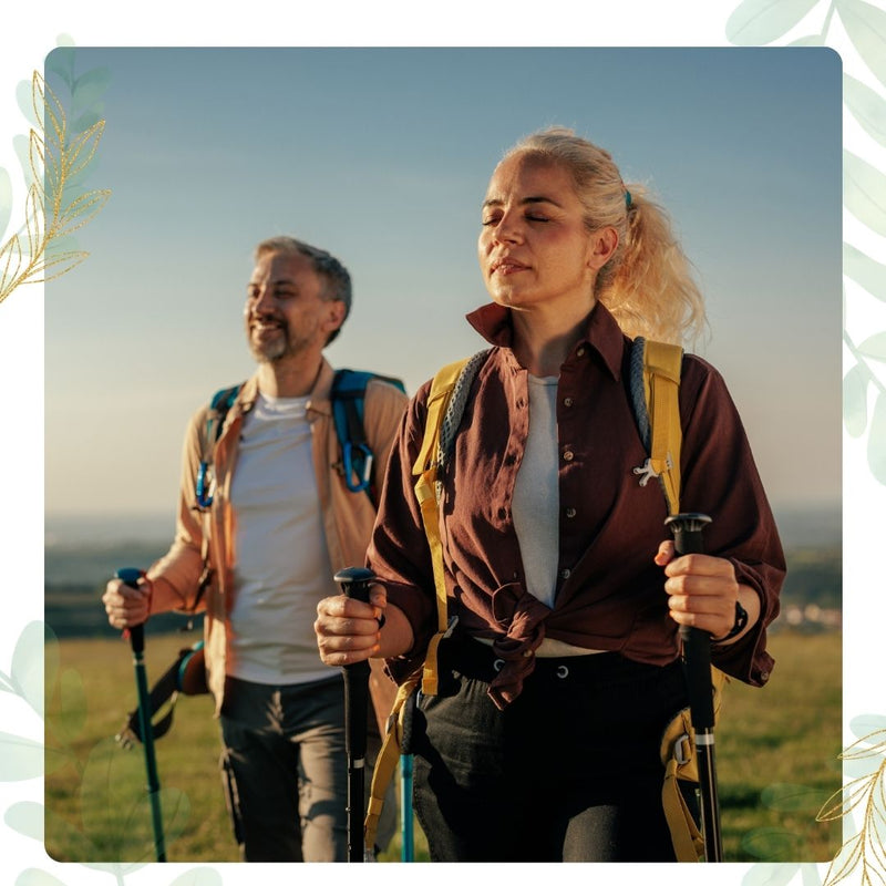 Couple hiking on a scenic outdoor trail with trekking poles