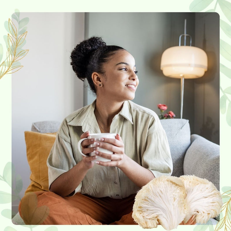 Woman sitting comfortably on a couch holding a warm cup with lion's mane mushrooms
