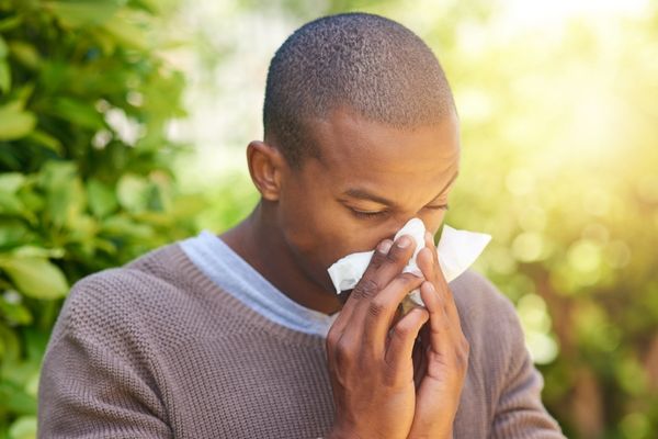 man blowing his nose